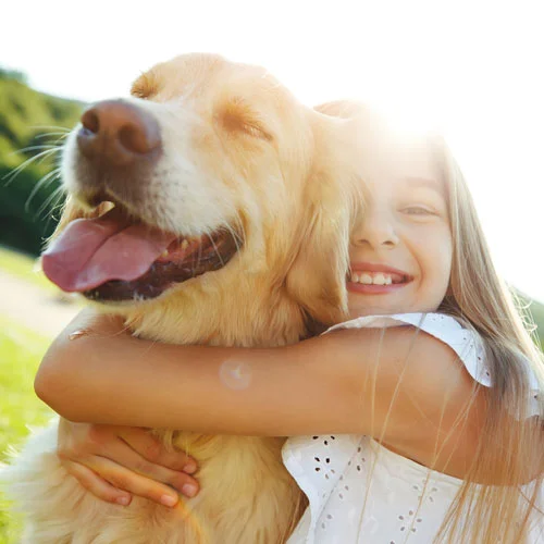 girl hugging dog