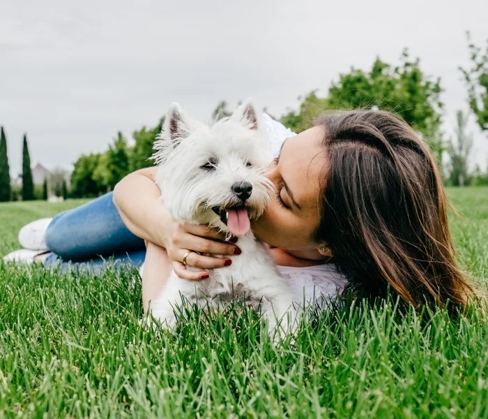 woman dog on grass