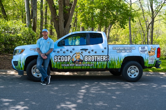 man in front of scoop brothers truck